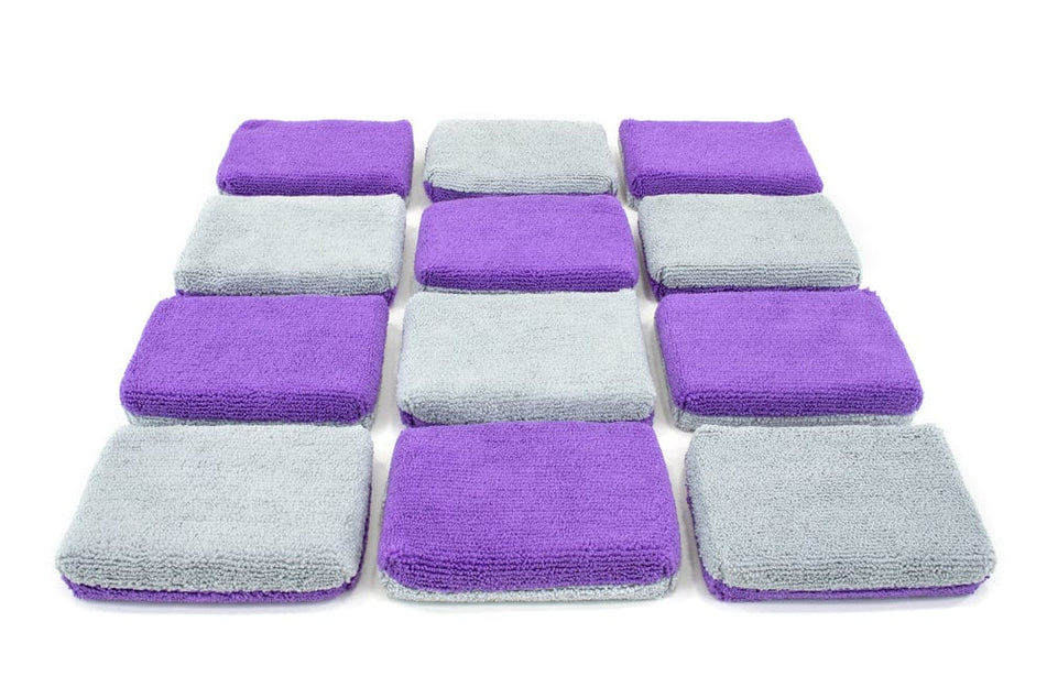 Twelve thin microfiber coating applicator sponges with purple and gray covers, arranged in a grid on white background