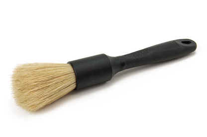 Boar hair detail brush with black ergonomic handle designed for precise cleaning and delicate surface scrubbing.