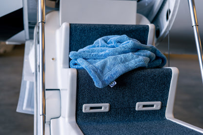 Blue AeroWipe Max large microfiber drying towel placed on aircraft boarding stairs for aviation detailing
