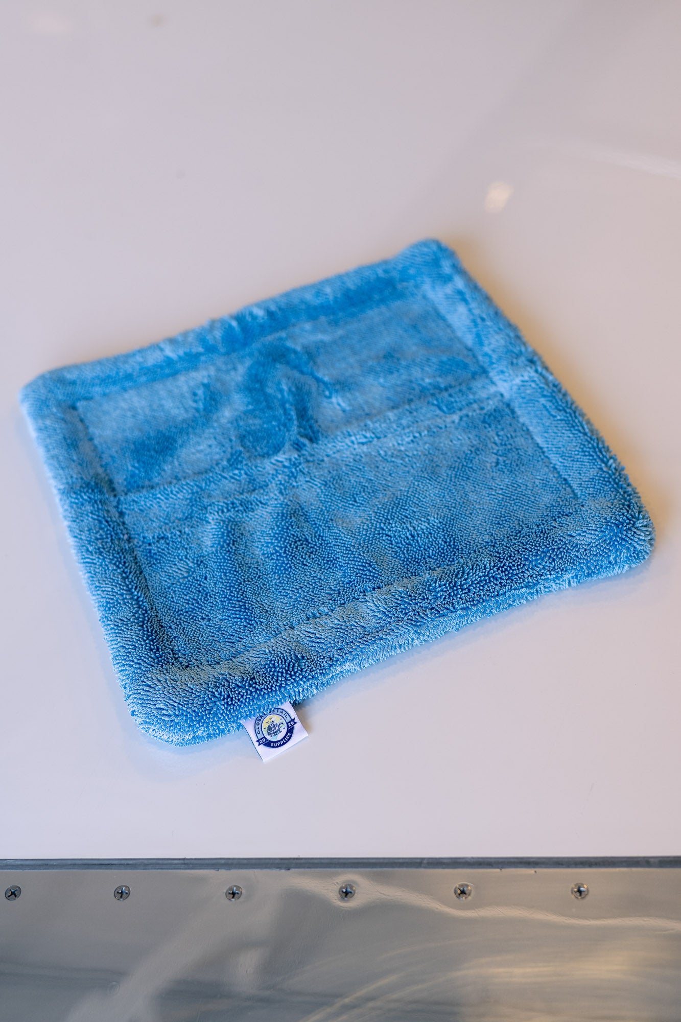 Blue AeroWipe Mini microfiber drying towel folded on white surface for aviation, auto, and marine detailing tasks