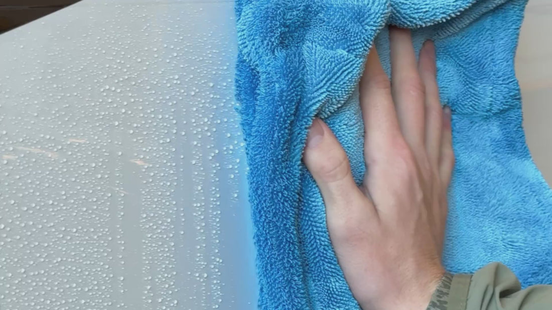 drying off exterior of plane with blue microfiber towel